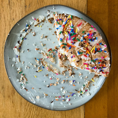 Angel Food Cake on Plate with Sprinkles and Icing