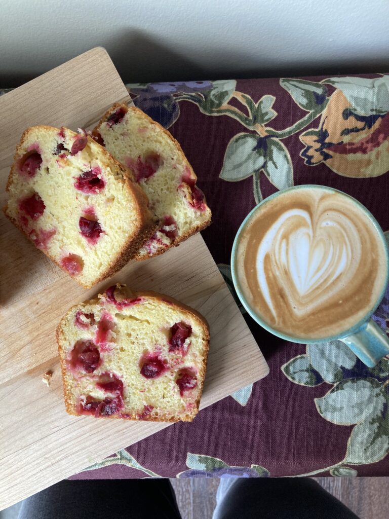 Slices of Baked French Yogurt Cake with Cranberries with a Latte